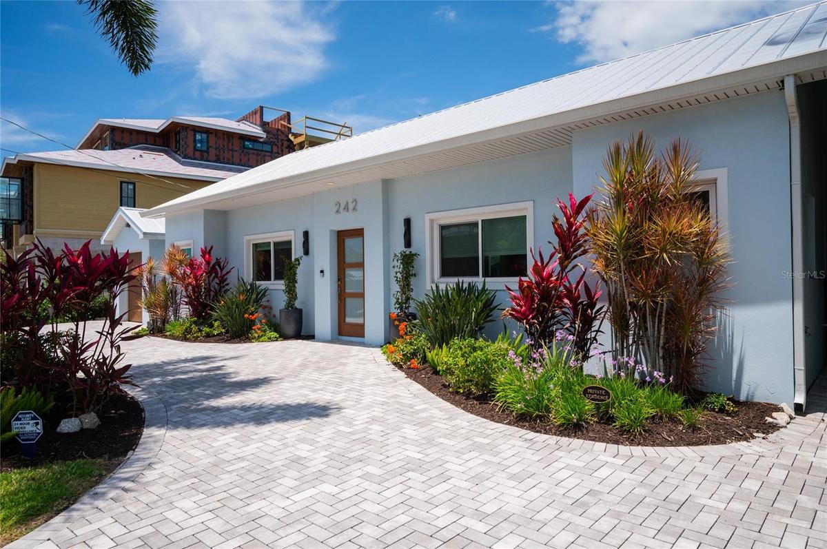 Beautifully landscaped property and a brick paver circular driveway