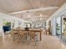 The dining area leads outside directly to a large deck where you can enjoy morning coffee al fresco.