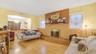 Living room with hardwood / wood-style flooring and a brick fireplace