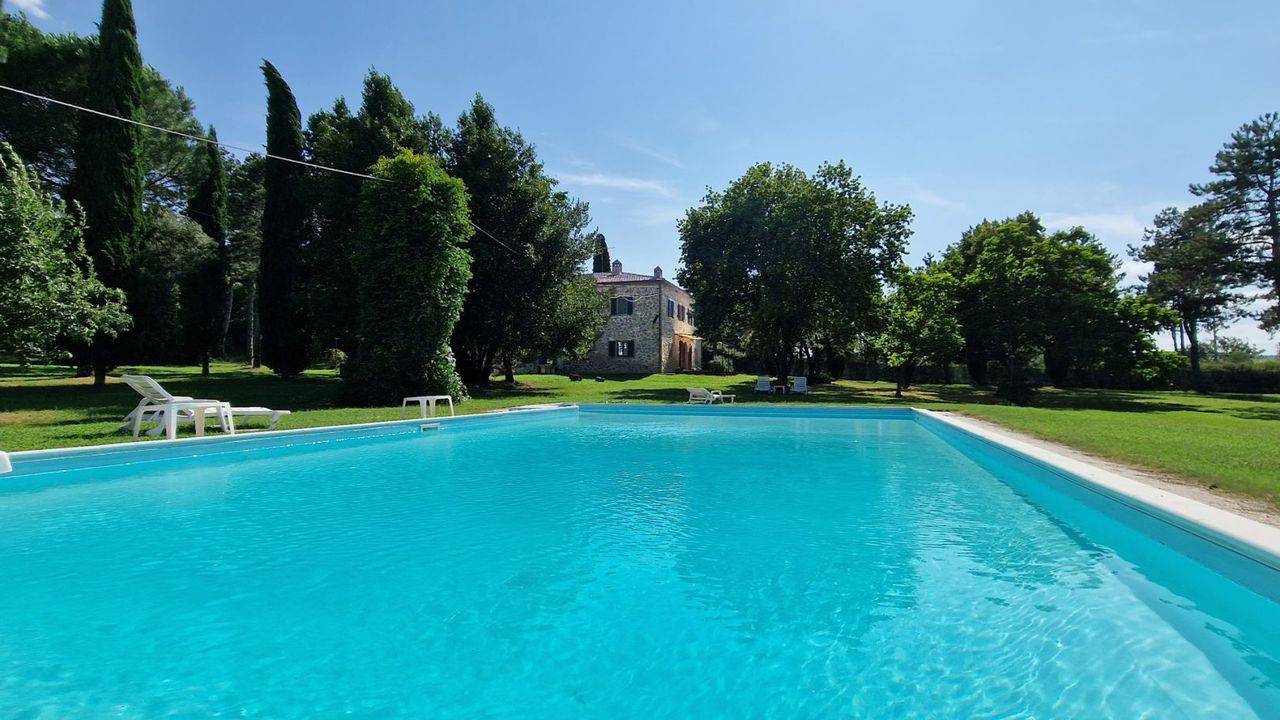Tuscan stone farmhouse with pool and land for sale in Lucignano, in the Tuscan countryside on the border between the provinces of Siena and Arezzo.