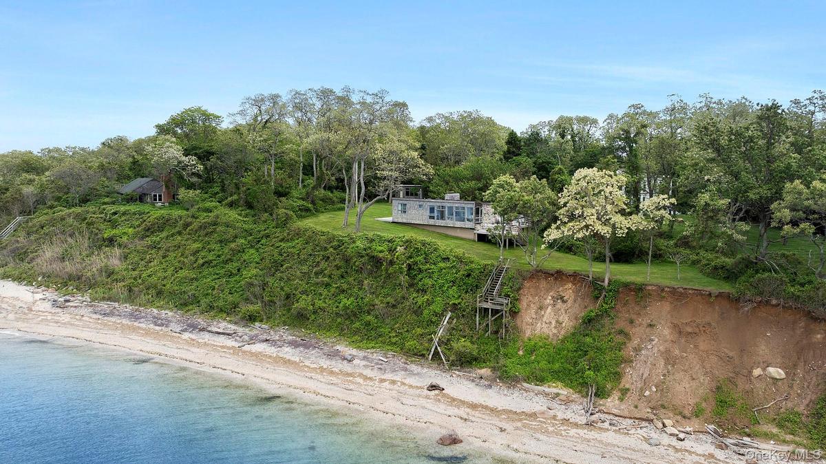 Aerial view of property's location with a large body of water