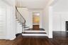 Stairs with wood finished floors, visible vents, and baseboards