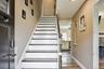 Staircase featuring wood finished floors and baseboards