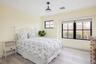 Bedroom with light wood finished floors and baseboards