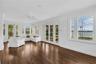 Sunroom with French doors leading to the beautiful backyard