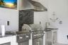 Summer kitchen with 30" Coyote built-in grill and outdoor griddle