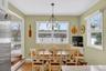 Dining area featuring wood finished floors, a chandelier, and plenty of natural light