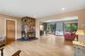 Living Room with Woodburning Fireplace and Entry into Room for Office-Playroom-Gym-4th Bedroom