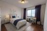 Bedroom with dark wood-style flooring and an office area