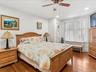 Bedroom featuring radiator, dark wood-type flooring, ceiling fan, and recessed lighting
