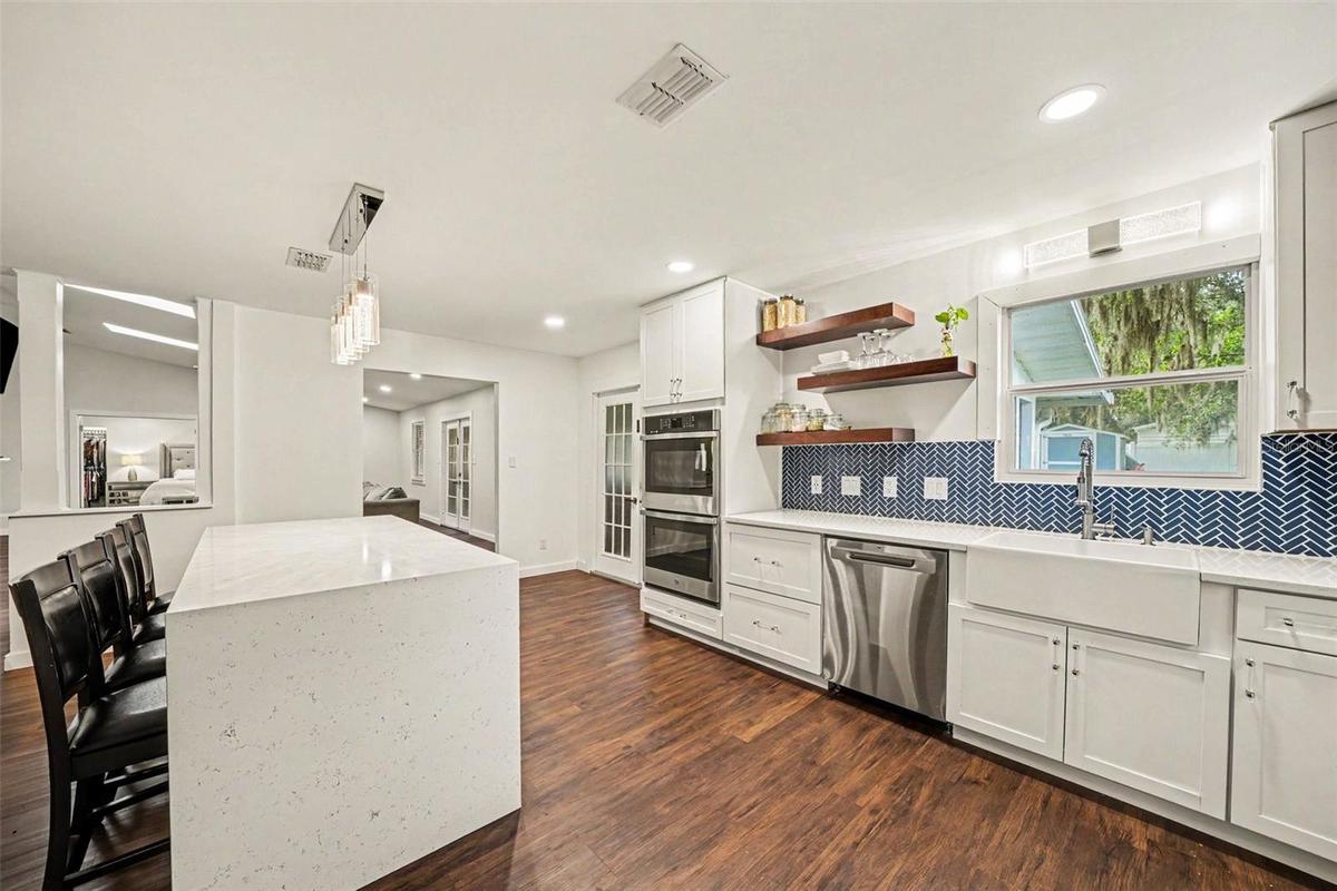 Gorgeous Kitchen with decorative blue tile backsplash & double Oven