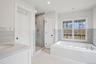 Bathroom with a stall shower, vanity, a tub with jets, and tile patterned floors