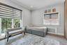 Room featuring wood-finish flooring, light grey walls, and white crown molding.