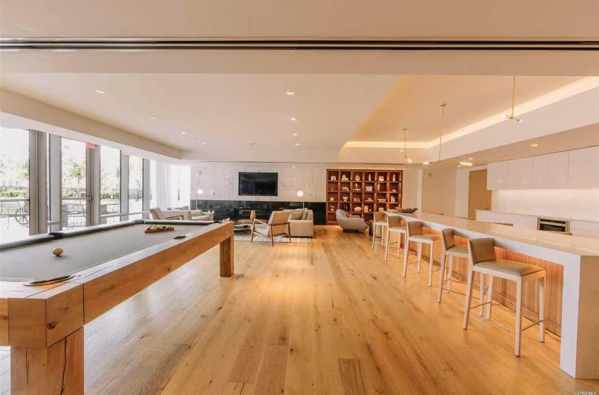 Game room featuring light wood finished floors, a fireplace, recessed lighting, a raised ceiling, and billiards