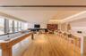 Game room featuring light wood finished floors, a fireplace, recessed lighting, a raised ceiling, and billiards