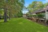 View of grassy yard with a deck