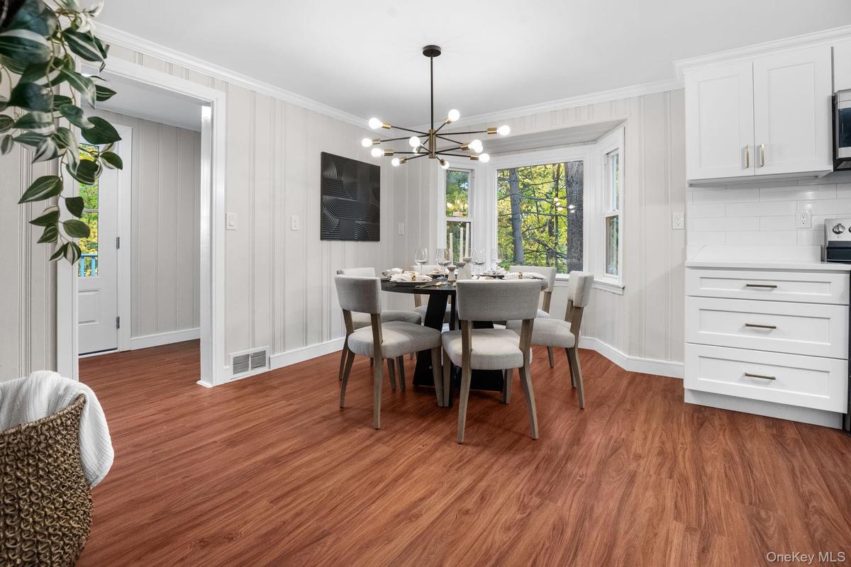 Charming dining nook with a modern chandelier and scenic window views, creating a warm setting for everyday meals or entertaining.