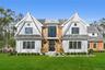 Shingle-style home with a front lawn