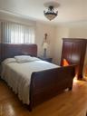 Bedroom with ornamental molding and light wood-style flooring