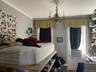 Bedroom featuring crown molding, wood finished floors, cooling unit, and a chandelier