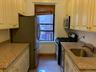 Kitchen with stainless steel appliances and light stone counters