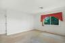 Primary bedroom showing more wall space and a linen closet & window facing the rear yard
