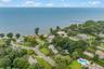 Aerial perspective of suburban area featuring a large body of water