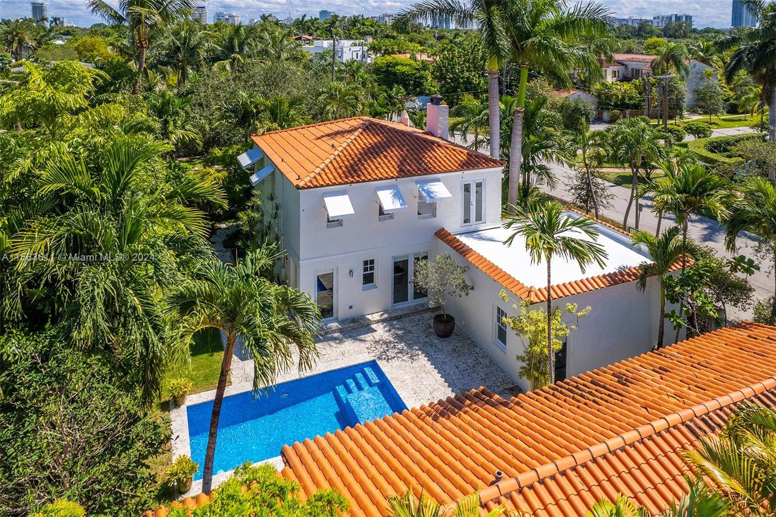Beautifully restored Mediterranean pool home w guest cottage on quiet corner lot in Miami Beach.