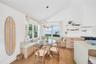 Dining room with breakfast area, light wood-type flooring, lofted ceiling, and a chandelier