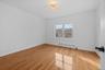 Unfurnished room featuring baseboard heating, light wood-style flooring, and a chandelier