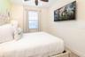 Bedroom with neutral tones and natural light in Kissimmee vacation home