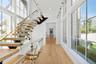 Stairway featuring plenty of natural light, wood finished floors, recessed lighting, and a towering ceiling