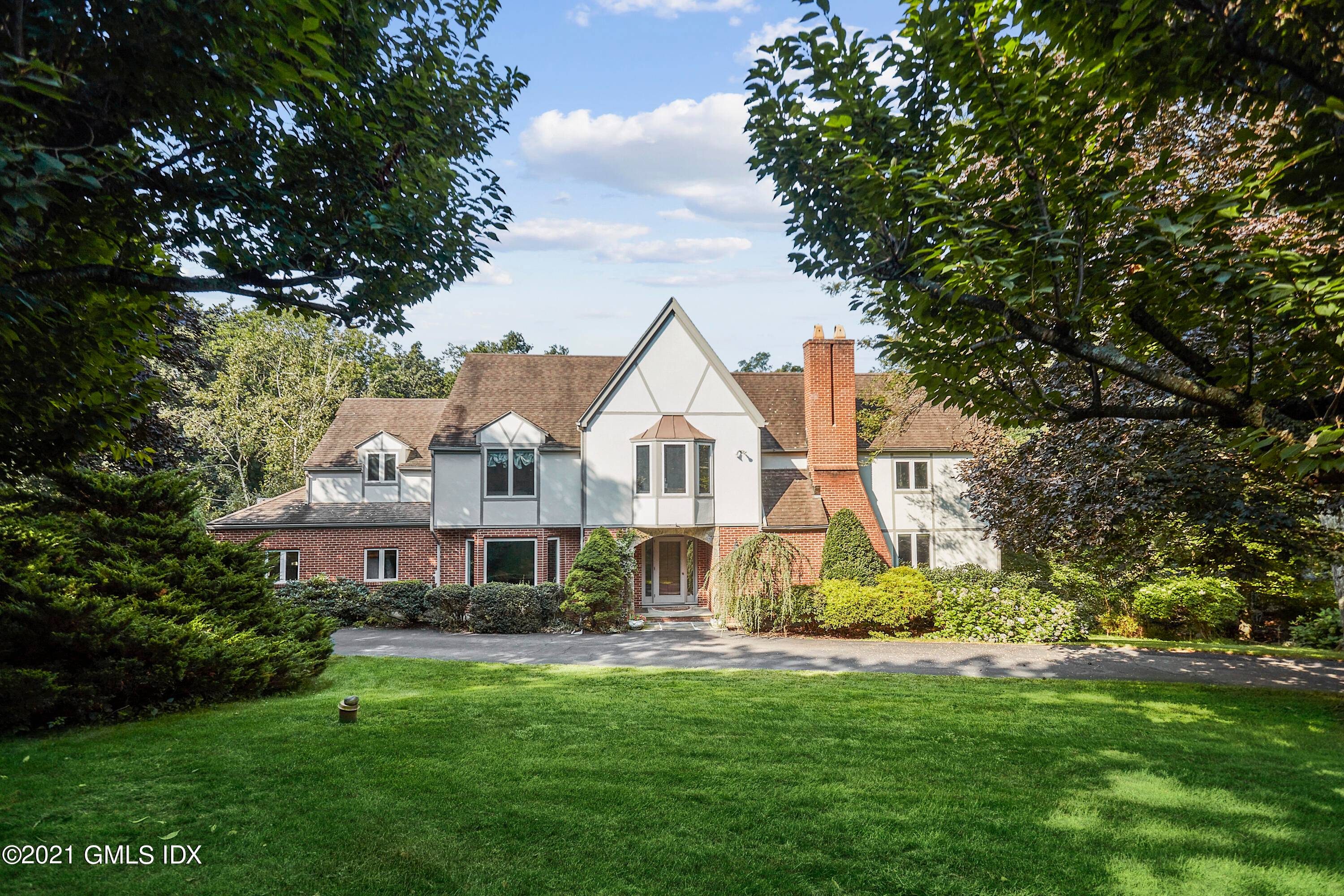 Stunning sunny 5 BR Tudor situated on quiet road adjacent to Mianus River Park with access to miles of trails.