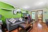 Living area featuring wood-finish flooring, recessed lighting, and bright green walls