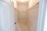 Spacious primary walk-in closet offering plenty of room for organization.