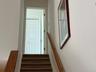 Stairs up to the third level and second bedroom