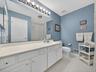 Bedroom level hall bathroom with shower over tub.