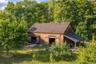 A beautifully restored 19th-century timber-frame barn, relocated from Cairo, New York, supporting the estate’s agricultural and horticultural operatio