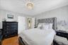 Primary bedroom featuring original hardwood floors and closet
