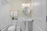 Bathroom featuring bath / shower combo with glass door, tile walls, wainscoting, and tile patterned floors