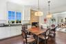 Dining room with ornamental molding, dark wood finished floors, and recessed lighting
