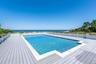 View of swimming pool with a deck with water view
