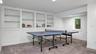 Recreation room with carpet flooring and built in features
