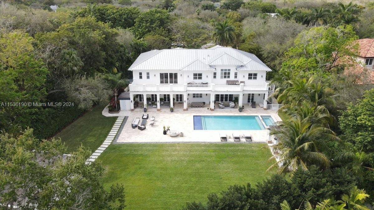 Whoever says love at first SITE isn t real has not seen this stunning 2 story Coastal Contemporary Estate on a North Pinecrest Acre.