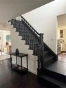 Stairs featuring crown molding, wood finished floors, and baseboards