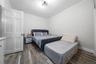Bedroom with ornamental molding and light wood finished floors