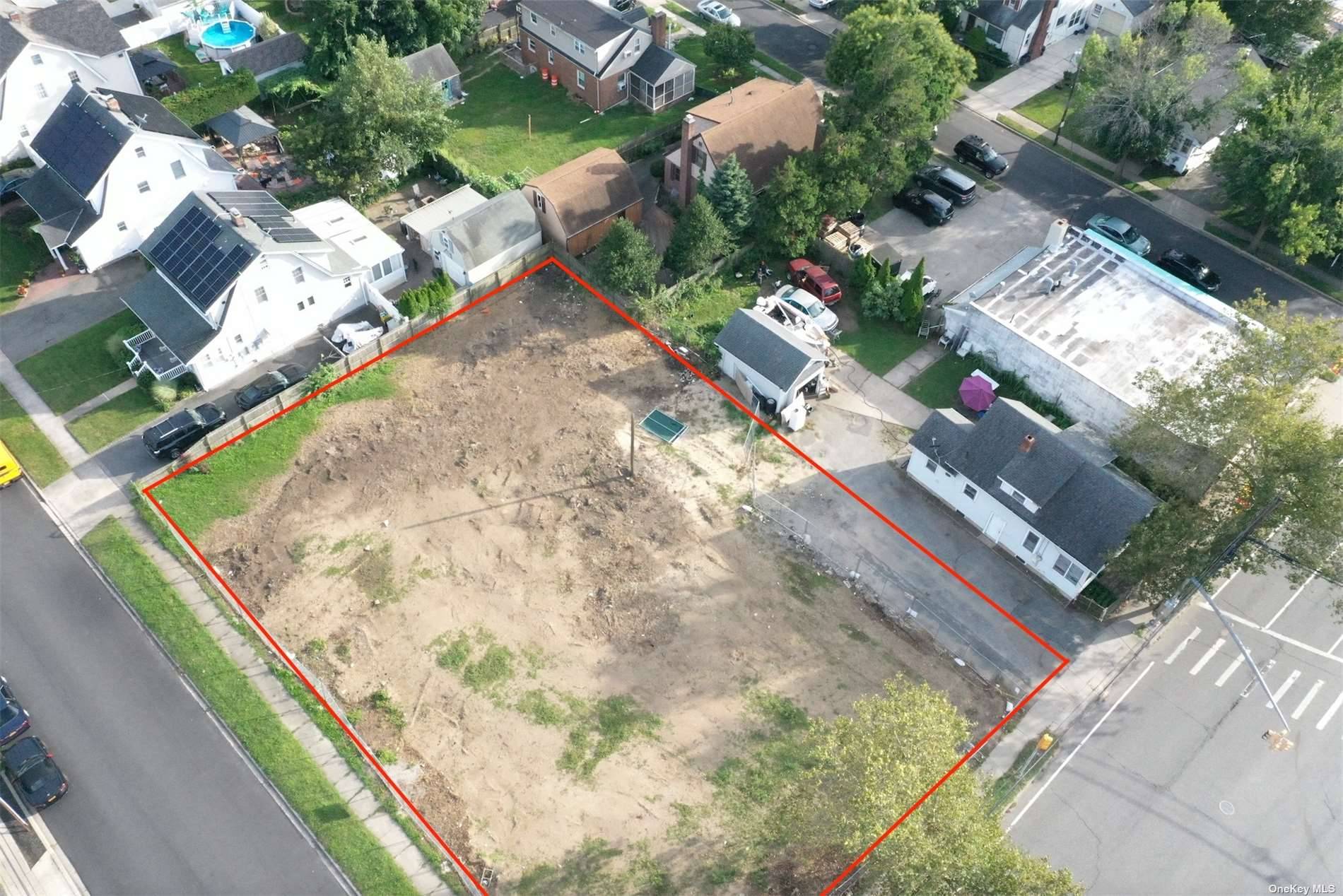 This buildable corner lot, which is in the process of being divided for two houses, is full of potential.