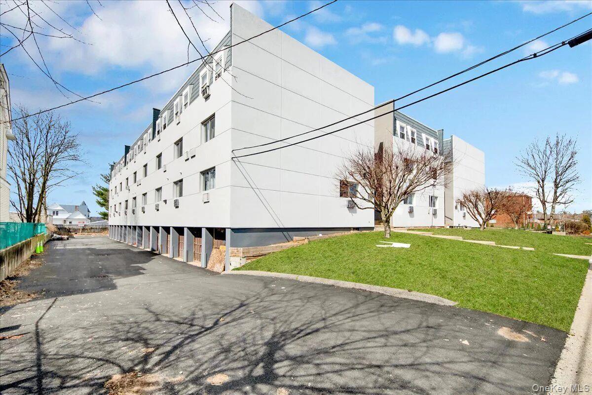Contemporary multi-story building featuring a light-colored facade