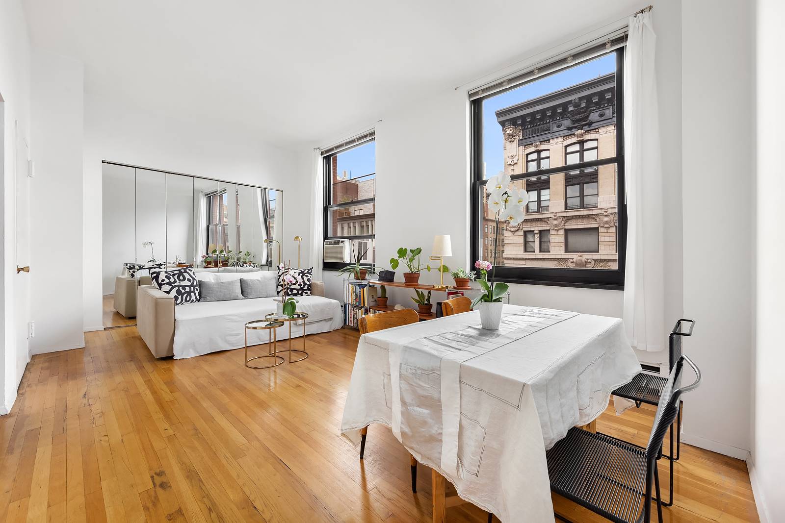 Large, sunny, loft like one bedroom apartment with massive windows and eastern light and views in a desirable full service building in fabulous Noho Greenwich Village.