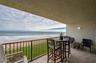 The private covered balcony offers a front-row seat to the Atlantic, with space for dining or lounging while taking in uninterrupted ocean views and t